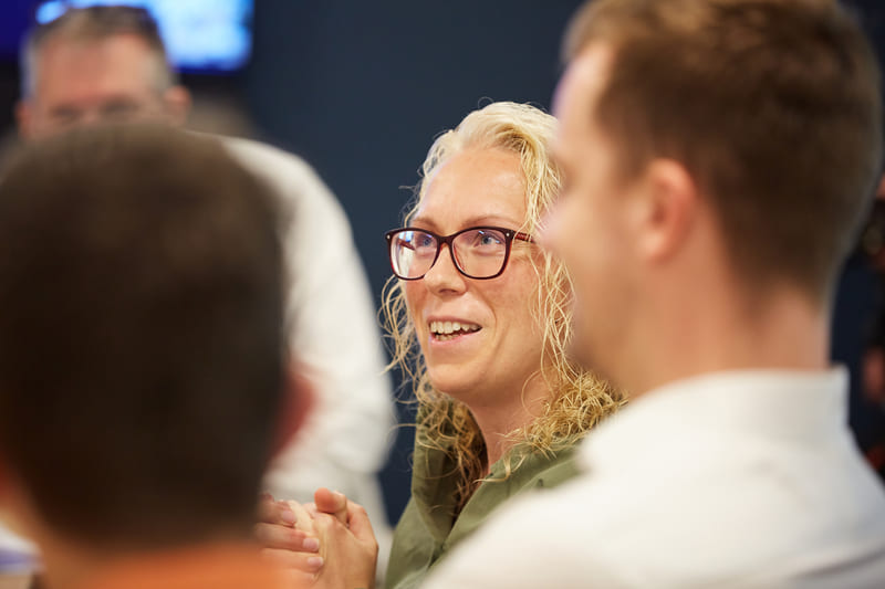 lady wearing glasses looking up and talking